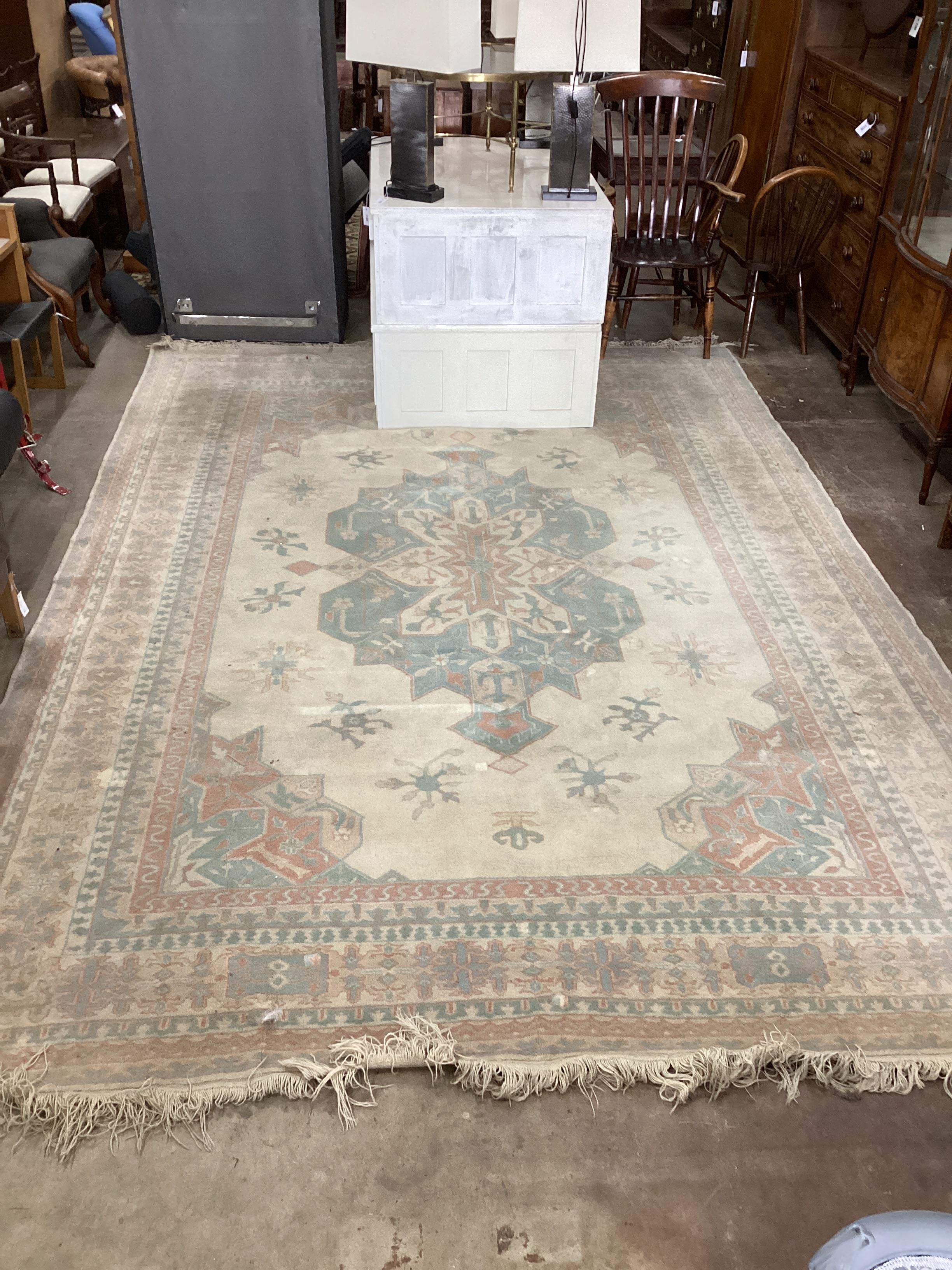 A Turkish ivory ground carpet, 386 x 264cm